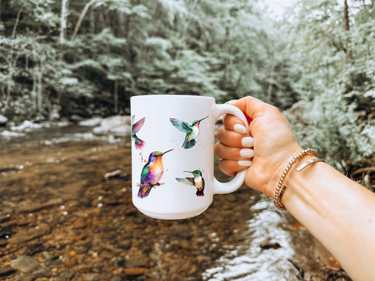 girl holding a cup with hummingbirds